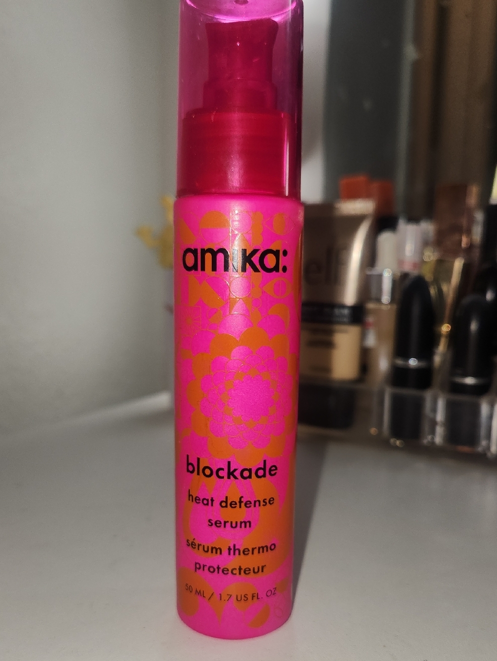 amika heat defense serum - pink & orange pump bottle